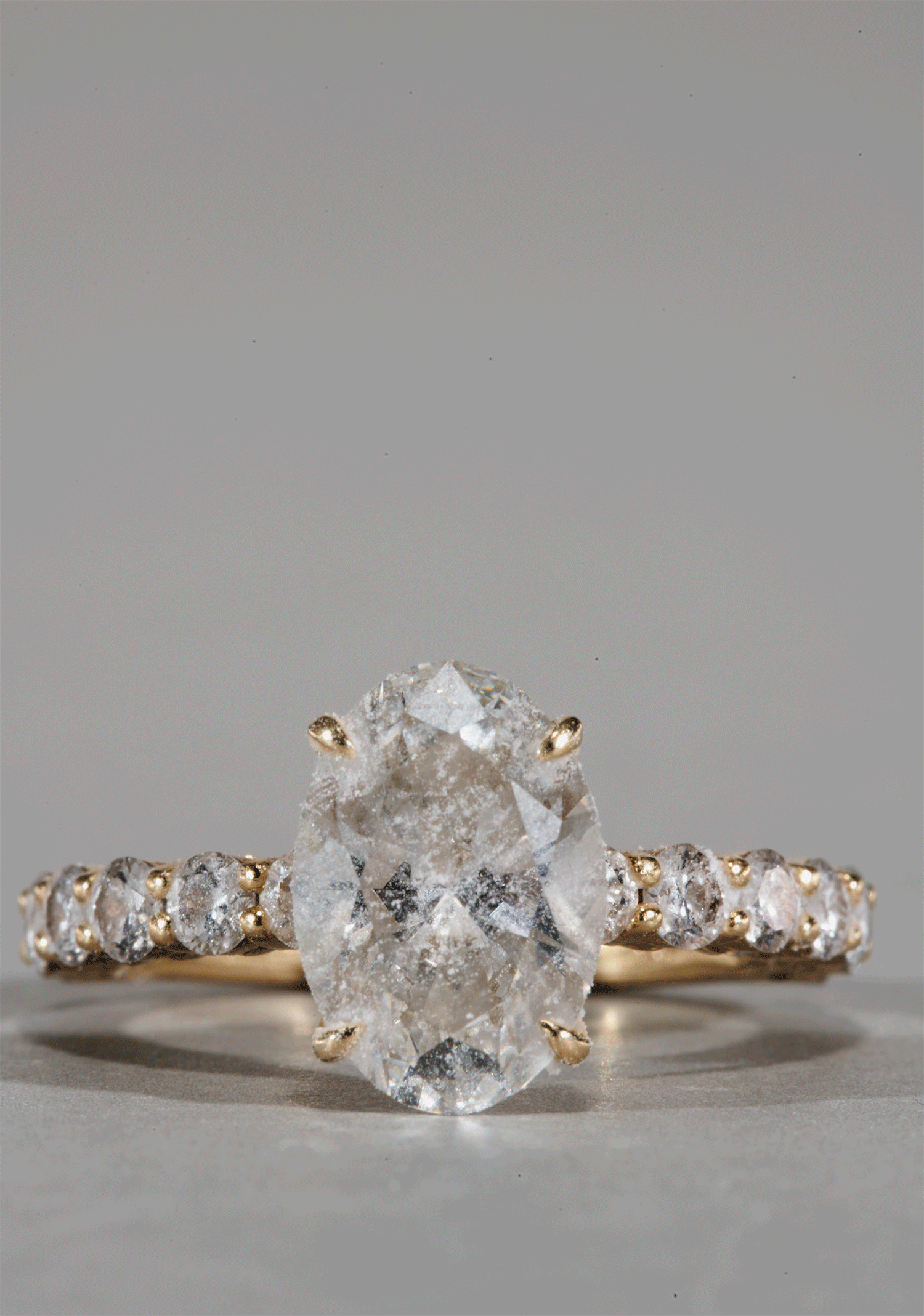 dirtydiamondengagementringbeingcleanedbydrdiamondjewellerycleaningpenwithgreybackground