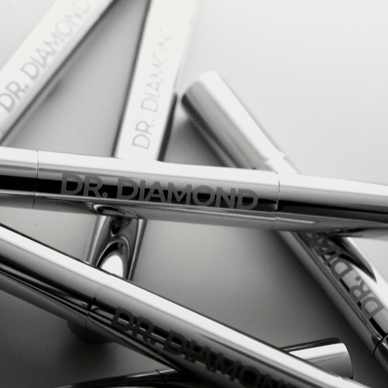 Close-up of Dr. Diamond jewellery cleaning pens on a light gray background
